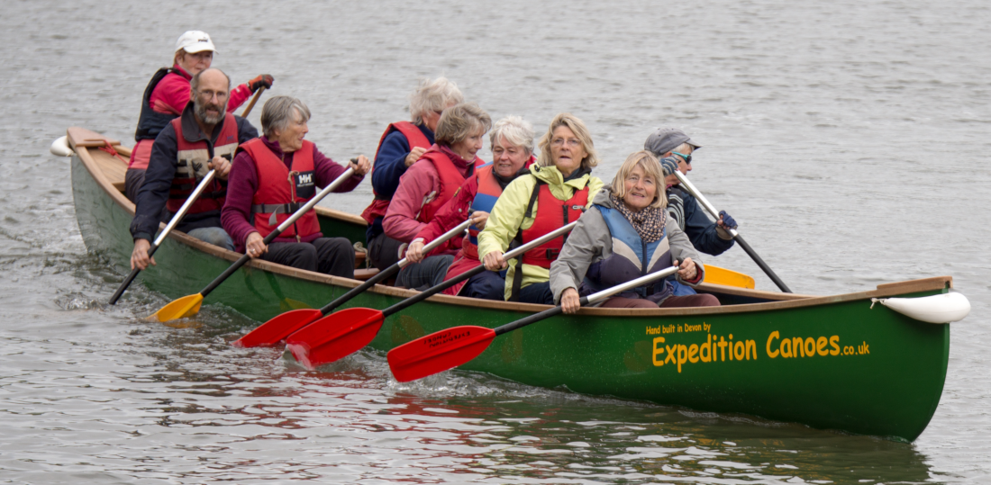 Group of retired people learning to canoe